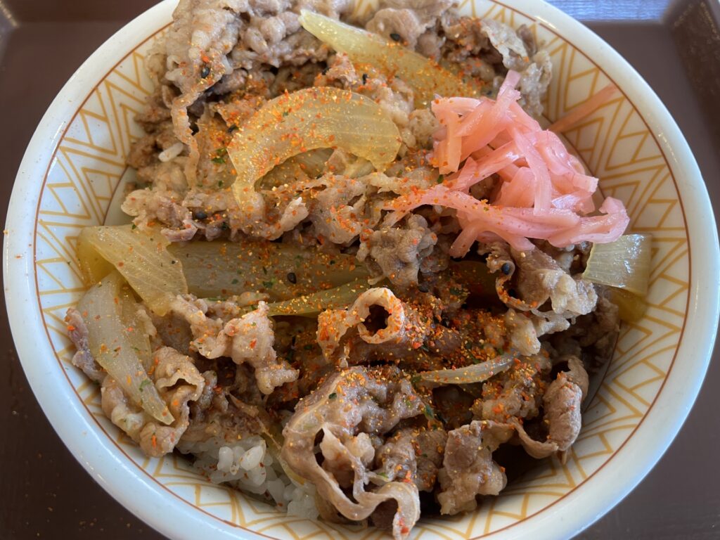 吉野家の牛丼を食べている人をイメージした画像
